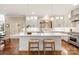 Bright kitchen with a large island, stainless steel appliances, and hardwood floors at 409 Running Horse Ln, Waxhaw, NC 28173