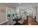 Open kitchen with stainless steel appliances, marble countertops, island and an adjacent breakfast area at 409 Running Horse Ln, Waxhaw, NC 28173