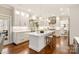 Bright kitchen with marble countertops, stainless steel appliances, white cabinetry, and a spacious center island at 409 Running Horse Ln, Waxhaw, NC 28173