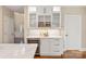 Well appointed kitchen features a wine cooler, custom cabinetry, marble countertops, and seamless access to the dining area at 409 Running Horse Ln, Waxhaw, NC 28173
