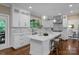 This kitchen features a center island, white cabinets, marble countertops and stainless steel appliances at 409 Running Horse Ln, Waxhaw, NC 28173