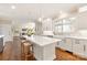 Bright and modern kitchen with white cabinetry and marble countertops at 409 Running Horse Ln, Waxhaw, NC 28173