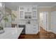Kitchen featuring wine cooler, marble countertops, pendant lights, and hardwood floors at 409 Running Horse Ln, Waxhaw, NC 28173