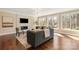 Cozy living room featuring a modern fireplace, hardwood floors, and plenty of natural light at 409 Running Horse Ln, Waxhaw, NC 28173
