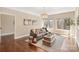 Living room with hardwood floors, a gray couch, and windows that offer plenty of natural light at 409 Running Horse Ln, Waxhaw, NC 28173