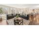 Open concept living room with hardwood floors, large windows, and comfortable seating for entertaining guests at 409 Running Horse Ln, Waxhaw, NC 28173