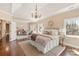 Spacious main bedroom and sitting room with hardwood floors, a chandelier, and plenty of natural light from multiple windows at 409 Running Horse Ln, Waxhaw, NC 28173