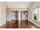 Spacious primary bedroom featuring hardwood floors, large windows, and custom closets with built-in shelving at 409 Running Horse Ln, Waxhaw, NC 28173