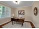 Bright home office with a large window, neutral decor, and stylish furnishings at 409 Running Horse Ln, Waxhaw, NC 28173