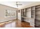 Bright home office with custom built-in shelves and desk, perfect for remote work or study at 409 Running Horse Ln, Waxhaw, NC 28173