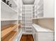 Walk in pantry with custom shelves, drawers, and marble countertop for optimized storage and organization at 409 Running Horse Ln, Waxhaw, NC 28173