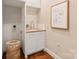 Stylish powder room featuring a vanity with stone countertop and modern faucet at 409 Running Horse Ln, Waxhaw, NC 28173