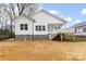 Newly constructed home backyard featuring a covered porch with white railings and a spacious yard ready for landscaping at 412 W Westview St, Gastonia, NC 28052