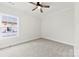 New carpeted bedroom with ceiling fan and bright window at 412 W Westview St, Gastonia, NC 28052