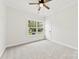 Bedroom featuring neutral carpeting, a ceiling fan, and an exterior view through the window at 412 W Westview St, Gastonia, NC 28052