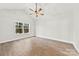 Bright bedroom with hardwood floors, ceiling fan, and a large window providing natural light at 412 W Westview St, Gastonia, NC 28052