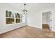 Dining room featuring hardwood floors, a modern chandelier, and a large window with an outdoor view at 412 W Westview St, Gastonia, NC 28052