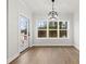 Dining room has an outdoor view with hardwood floors, a modern light fixture and access to the backyard at 412 W Westview St, Gastonia, NC 28052