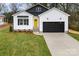 Charming new construction home featuring a black garage door and a bright yellow front door at 412 W Westview St, Gastonia, NC 28052