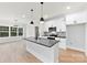 The kitchen has stainless appliances, white cabinets, a gray backsplash, black countertops, and a center island at 412 W Westview St, Gastonia, NC 28052