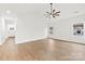 Living room has hardwood floors, a ceiling fan, and two windows with natural light coming through at 412 W Westview St, Gastonia, NC 28052