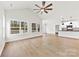 Spacious living room with a high ceiling, fan, multiple windows for natural light, and hardwood floors at 412 W Westview St, Gastonia, NC 28052