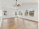 Living room with hardwood floors, ceiling fan and multiple windows providing lots of natural light at 412 W Westview St, Gastonia, NC 28052