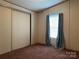 Bedroom featuring a sliding closet door and a window with curtains at 459 Towell St, Mooresville, NC 28115