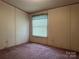 Bedroom featuring a window with blinds and patterned walls at 459 Towell St, Mooresville, NC 28115