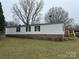 The home features a classic design with a brick foundation and a well-manicured lawn at 459 Towell St, Mooresville, NC 28115