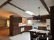 Spacious eat-in kitchen featuring linoleum floors, dark cabinets, and a skylight at 459 Towell St, Mooresville, NC 28115