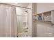 Bathroom featuring a white tub/shower combo with curtain and storage shelves on the adjacent wall at 502 Tayberry Ln, Fort Mill, SC 29715