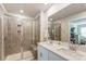 Modern bathroom featuring a tiled shower with glass door and double sink vanity with a large mirror at 502 Tayberry Ln, Fort Mill, SC 29715