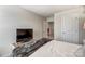 Bedroom showcasing a bed with gray patterned blanket and a TV on a wooden media stand at 502 Tayberry Ln, Fort Mill, SC 29715