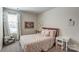 Light and airy bedroom with patterned bedding, a window with curtains, and decorative wall art at 502 Tayberry Ln, Fort Mill, SC 29715