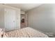 Cozy bedroom with neutral walls and carpet, showing view to small office space at 502 Tayberry Ln, Fort Mill, SC 29715