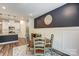 Bright dining area adjacent to kitchen with modern lighting, round wood table, and four wooden chairs at 502 Tayberry Ln, Fort Mill, SC 29715