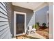 Inviting front entryway with a dark door, a charming bench, and a 'Hello Gorgeous' welcome mat at 502 Tayberry Ln, Fort Mill, SC 29715
