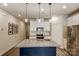 Modern kitchen features stainless steel appliances, granite countertops, and a large island with a sink and pendant lighting at 502 Tayberry Ln, Fort Mill, SC 29715