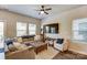 Cozy living room featuring a comfortable sectional, stylish decor, and large windows for natural light at 502 Tayberry Ln, Fort Mill, SC 29715