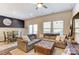 Open-concept living room with large sectional couch, dining area, and plenty of natural light at 502 Tayberry Ln, Fort Mill, SC 29715