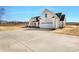 Exterior view highlighting new driveway and the side of a white modern farmhouse-style home at 520 Shoal Rd, Lincolnton, NC 28092