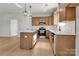 Well-lit kitchen featuring wooden cabinets, an island, and stainless steel appliances at 520 Shoal Rd, Lincolnton, NC 28092