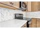 The kitchen features stainless steel appliances and quartz countertops at 520 Shoal Rd, Lincolnton, NC 28092