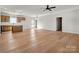 Open-concept living room and kitchen with hardwood floors and modern lighting at 520 Shoal Rd, Lincolnton, NC 28092