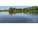 Scenic view of a tranquil pond reflecting lush greenery, creating a serene natural setting at 7212 Capstan Ter, Charlotte, NC 28269