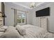 Bedroom featuring neutral tones, a tray ceiling, and a large window for natural light at 824 Imperial Ct, Charlotte, NC 28273