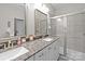 Bathroom with double sinks, stone countertop, and a glass-enclosed shower at 824 Imperial Ct, Charlotte, NC 28273