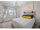 Cozy bedroom with a modern light fixture and a large window letting in plenty of natural light at 824 Imperial Ct, Charlotte, NC 28273