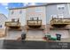 Rear view of townhomes with individual balconies above garage doors at 824 Imperial Ct, Charlotte, NC 28273
